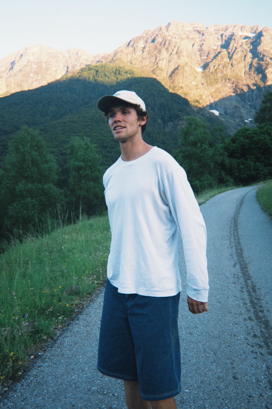Sven Madeiski on a mountain road in front of sunlit peaks
